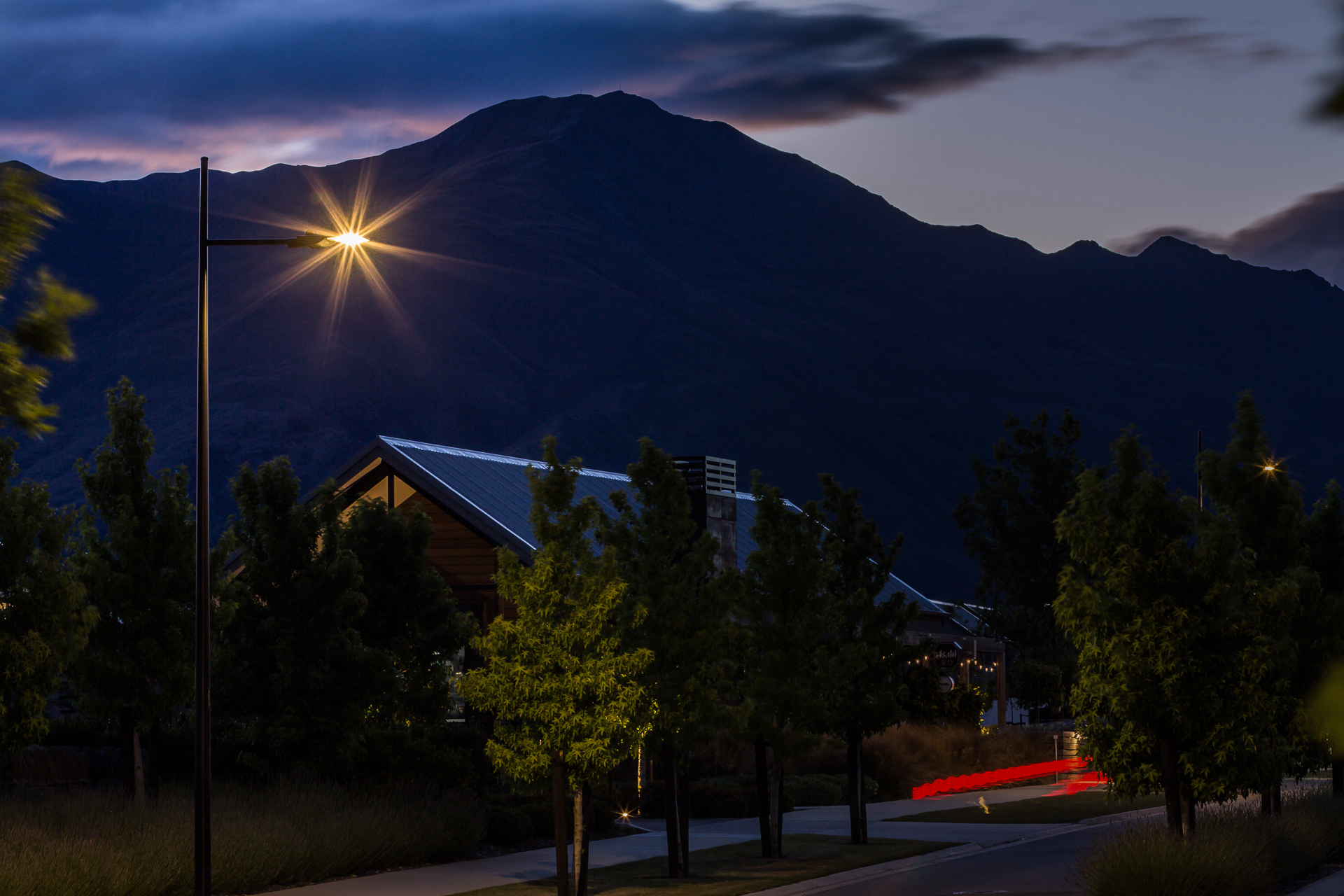 A residential street illuminated by Ibex Lighting at twilight.