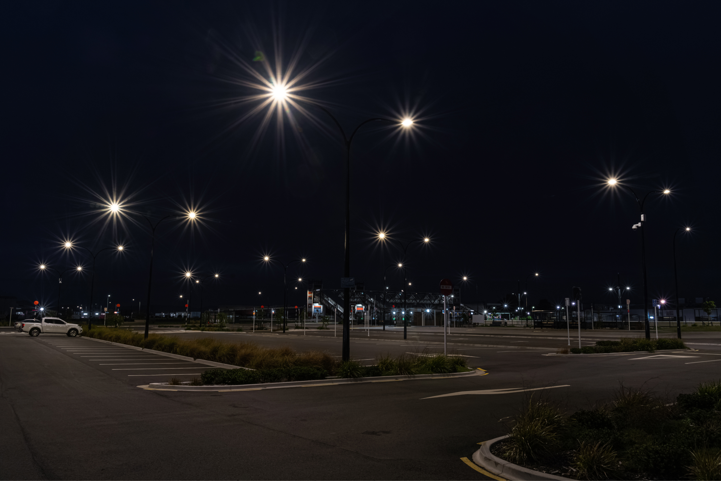 Street lights in a parking lot at night, powered by Ibex lighting.