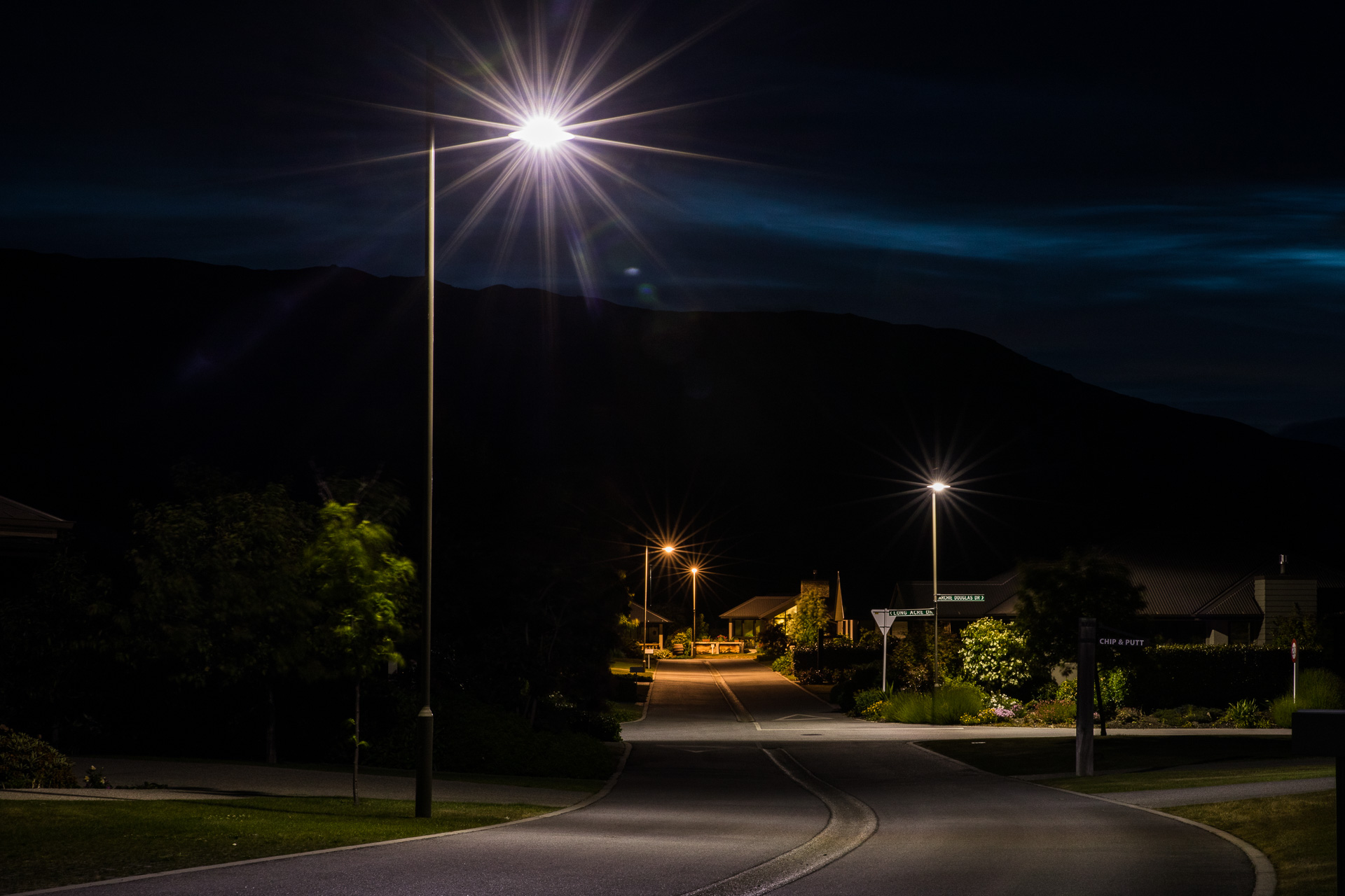 Aspiring retirement village at night illuminated by ibex street poles.