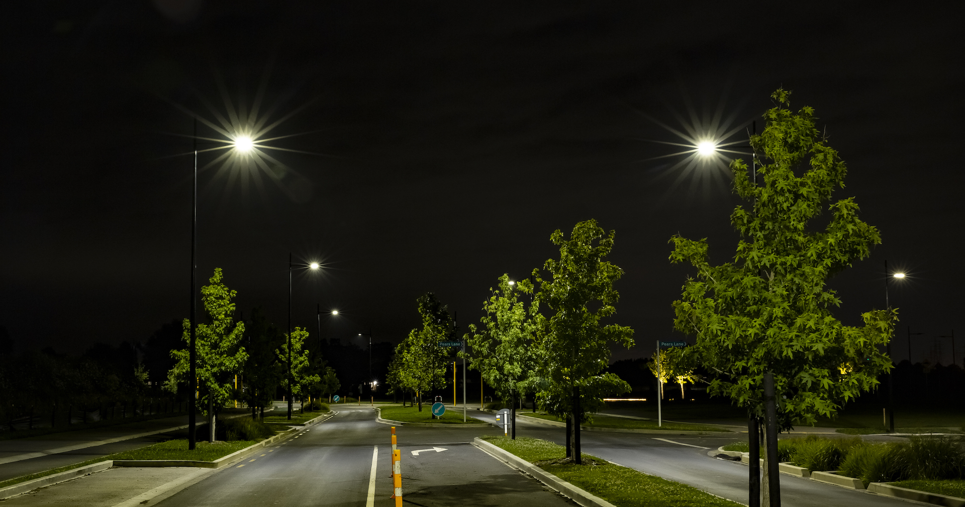 Auranga tree-lined street by night, presenting Ibex Lighting's lighting solution.