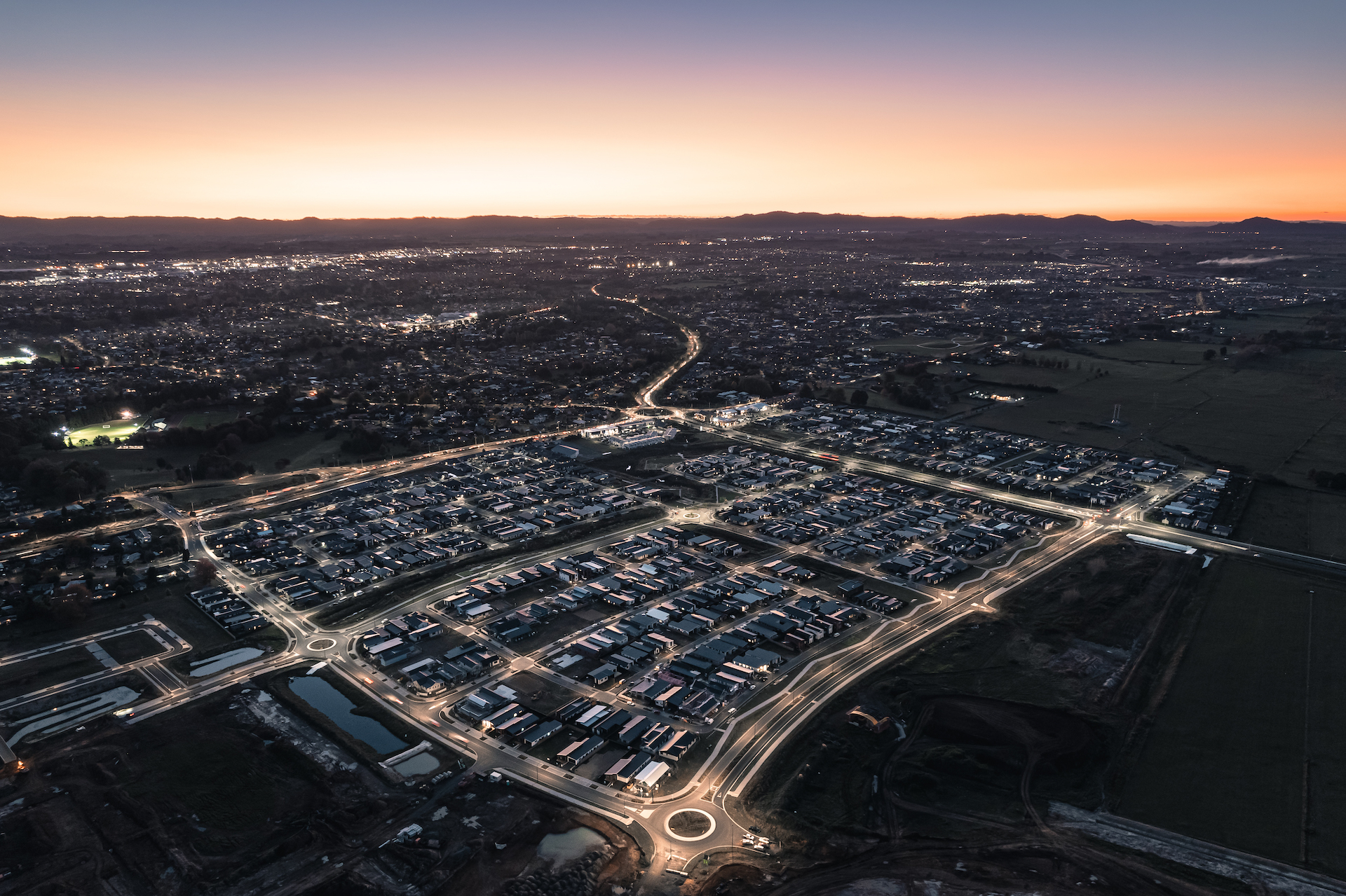 An aerial view of Greenhill at dusk, illuminated by ibex lighting.