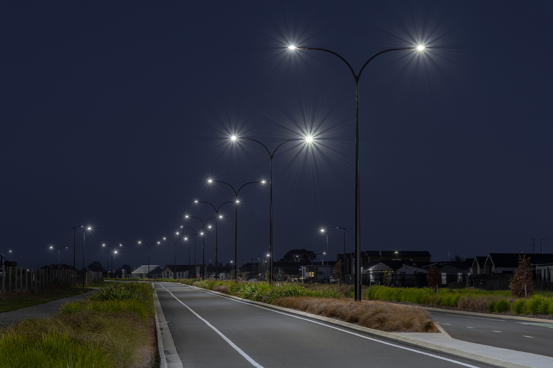 Greenhill Park street at night with light poles supplied and installed by Ibex Lighting.