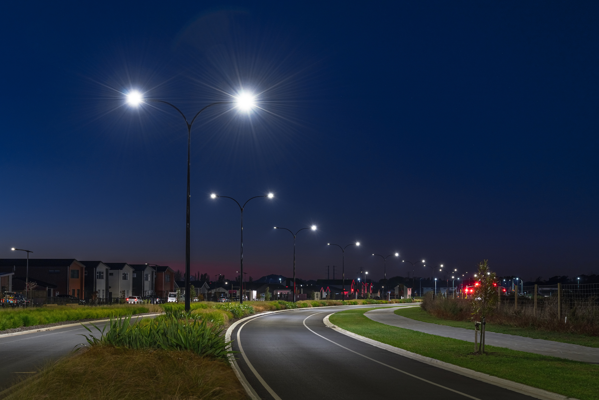 Greenhill Park street at night with light poles supplied and installed by Ibex Lighting.
