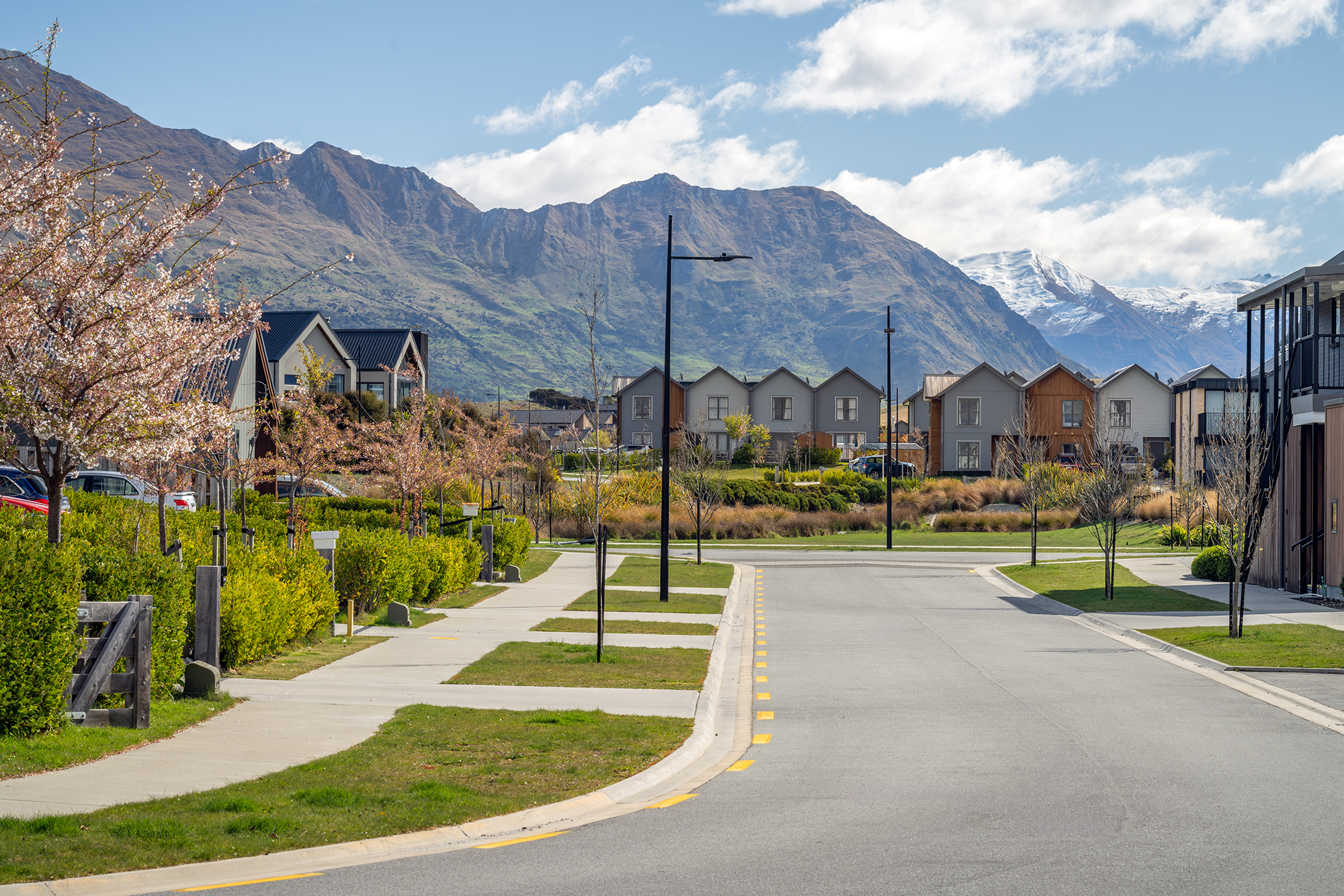 Northlake neighbourhood road illuminated by ibex lighting solutions with magnificent mountain in the background.
