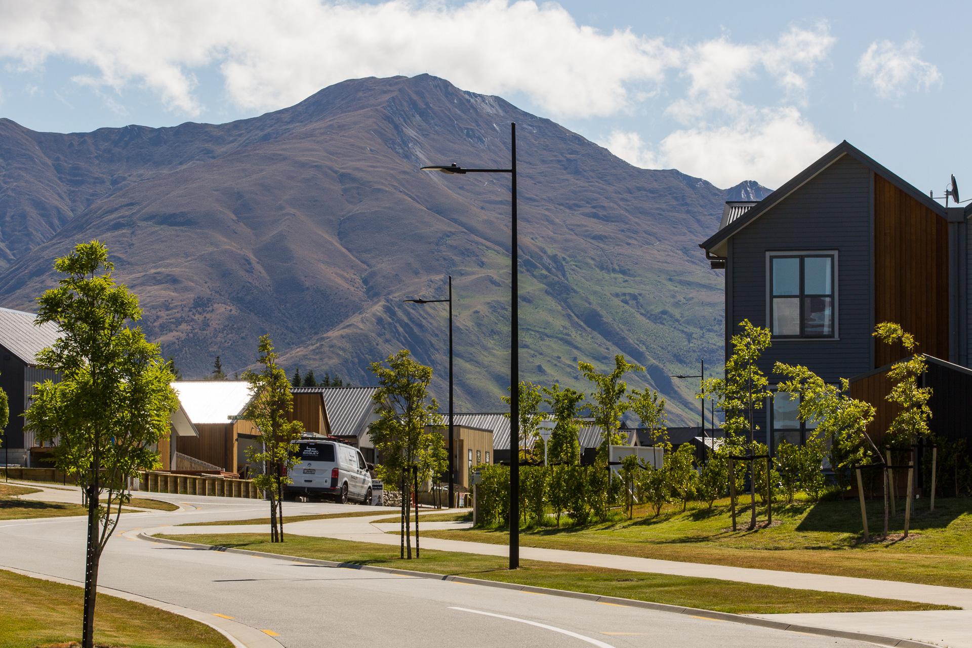 Northlake neighbourhood road illuminated by ibex lighting solutions with magnificent mountain in the background.